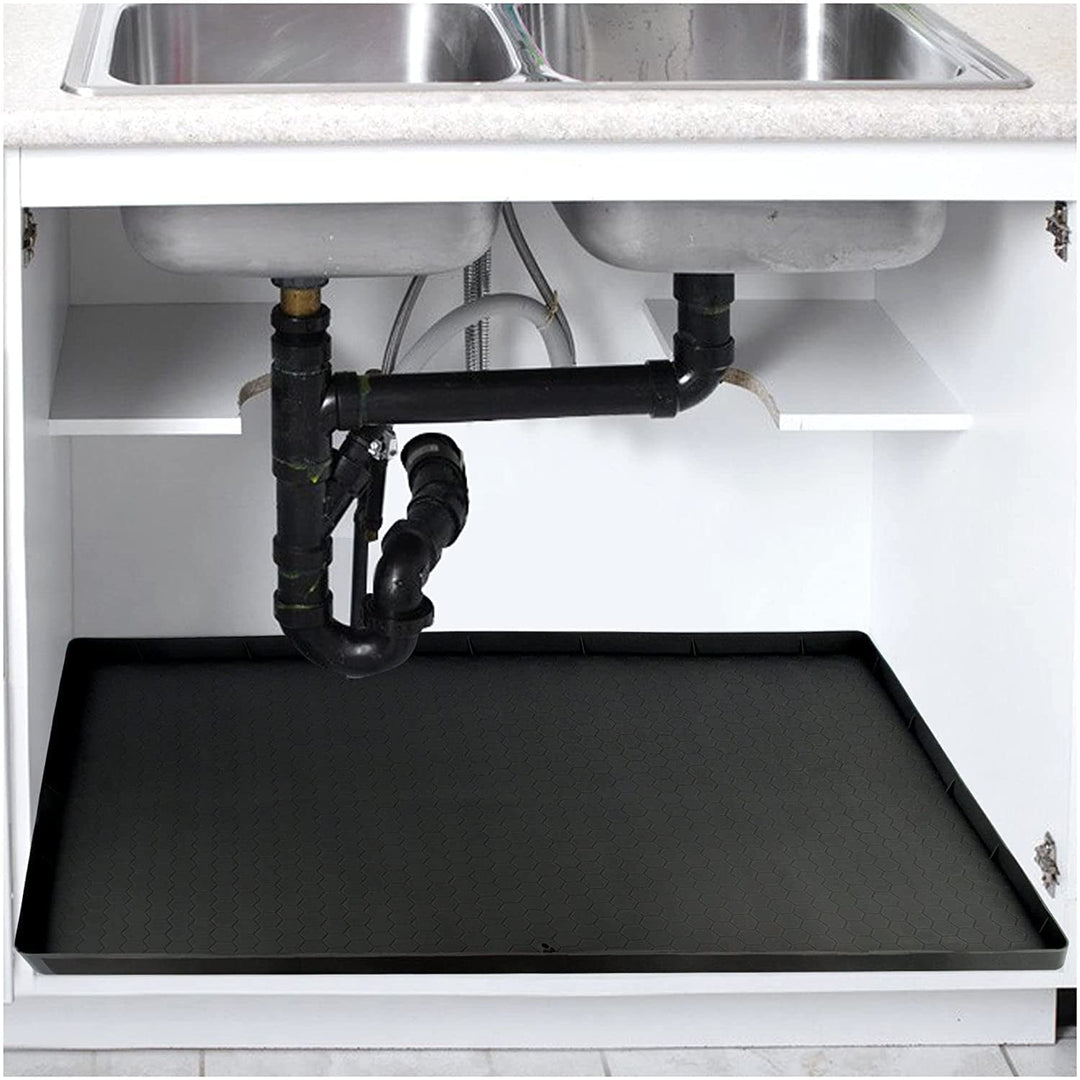 Black silicone under-sink mat shown inside a kitchen cabinet