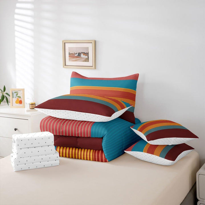 Folded striped comforter, sheets and pillow covers