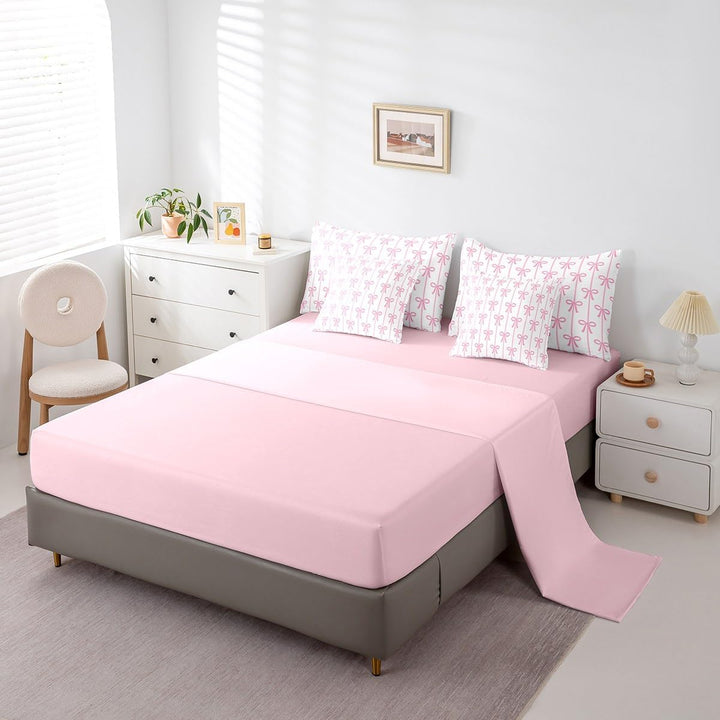 Pink fitted sheet and patterned pillowcases