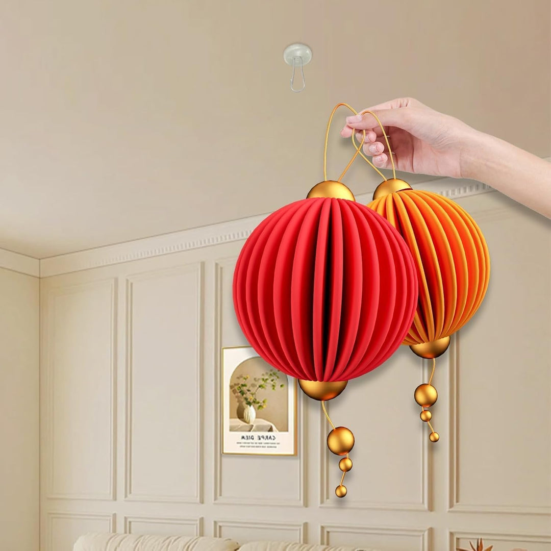 Clear adhesive hanging hook supporting a paper lantern