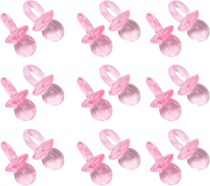 Pink mini pacifier charms arranged on white background