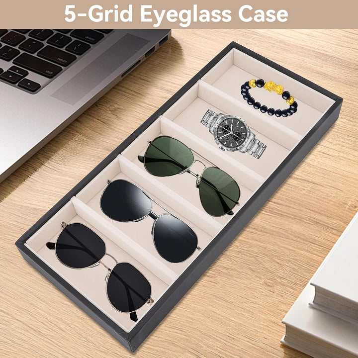 Black tray displaying sunglasses and jewelry