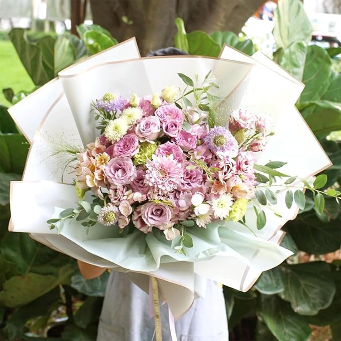 Pink flower bouquet wrapped in white gold-edge paper