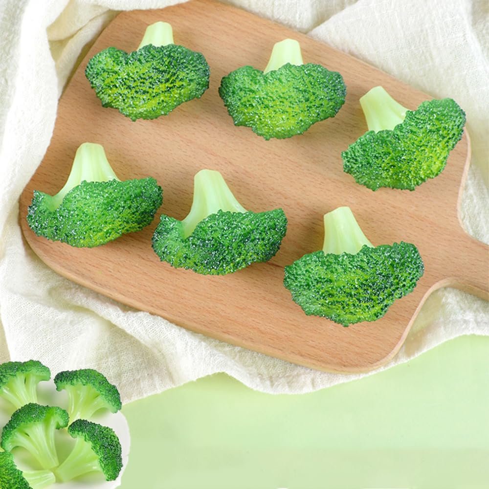 Six decorative broccoli florets arranged on a tray