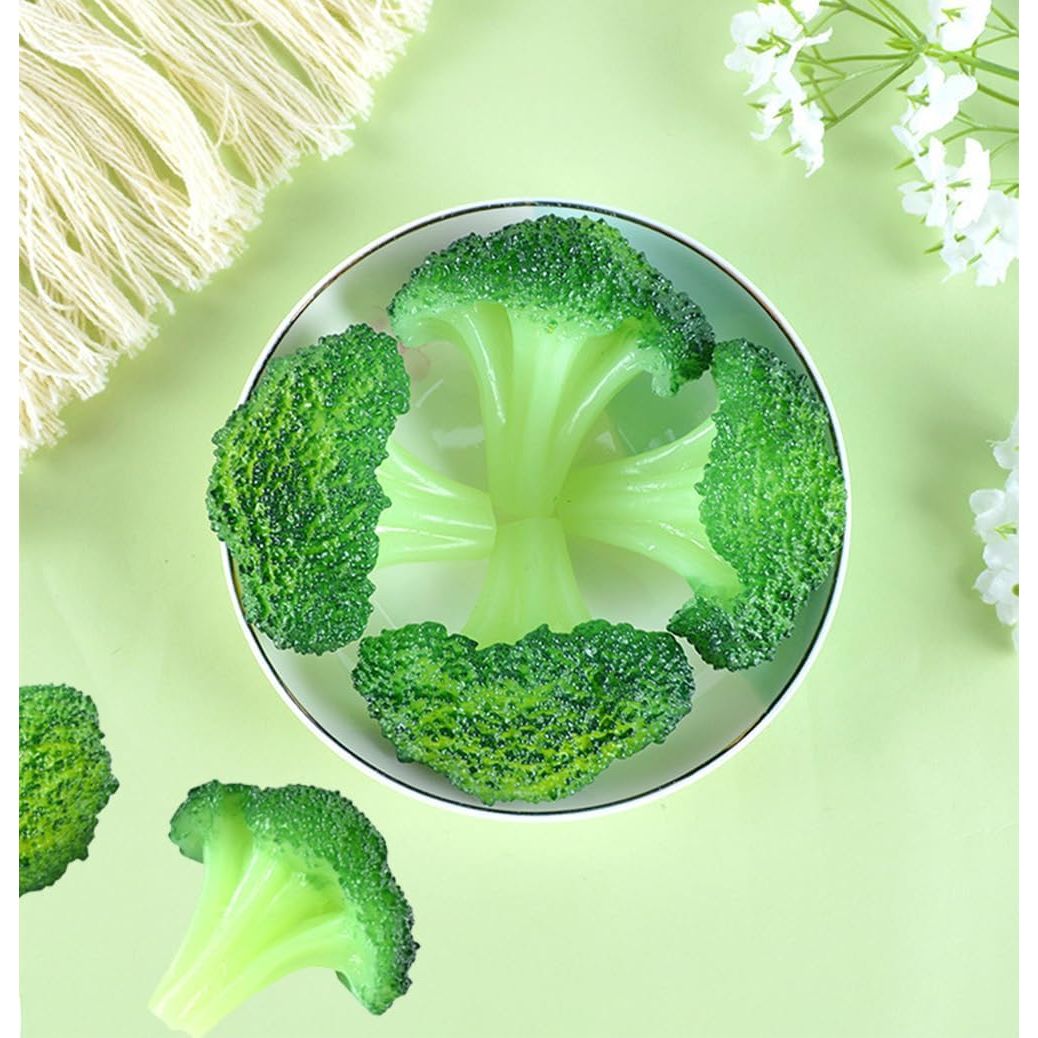 Artificial broccoli florets arranged in a bowl for display