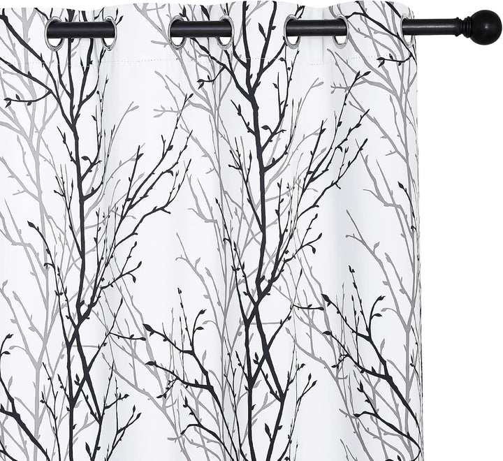Black and grey branch-print curtain grommets and pattern detail