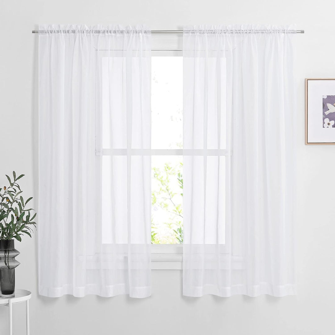 White 60 by 63 inch sheer rod-pocket curtain pair installed