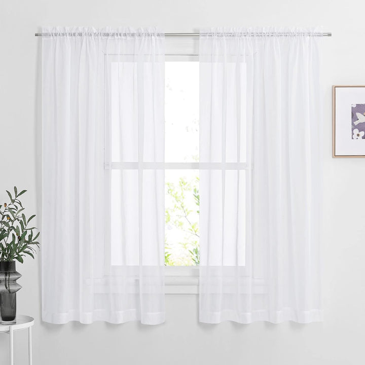 White 60 by 63 inch sheer rod-pocket curtain pair installed