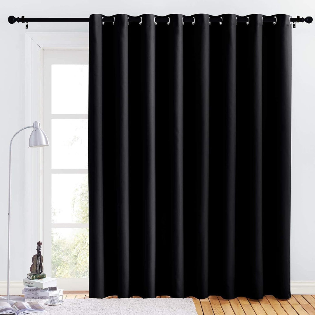 Black 120 x 84 inch blackout room divider panel hanging across window