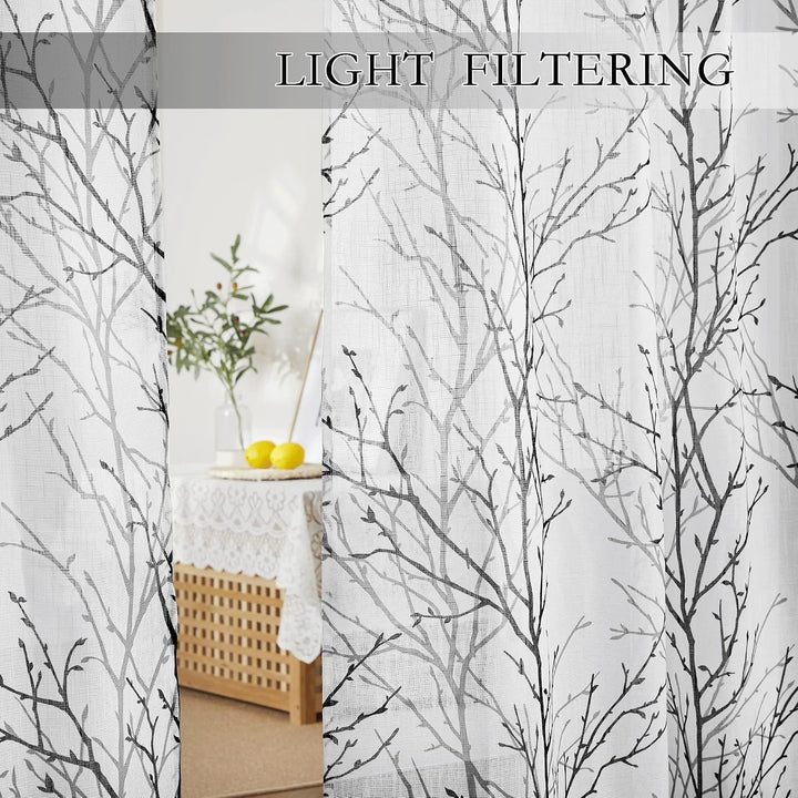 Light filtering through branch-print sheer curtains