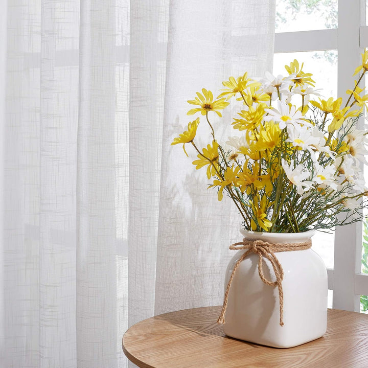 White semi-sheer woven curtain fabric filtering light