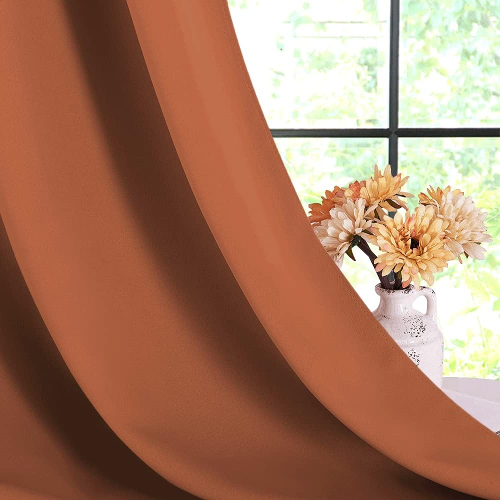 Burnt-orange blackout curtain fabric drape close-up