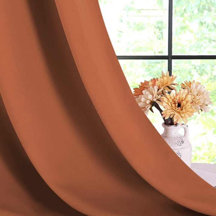 Burnt-orange blackout curtain fabric drape close-up