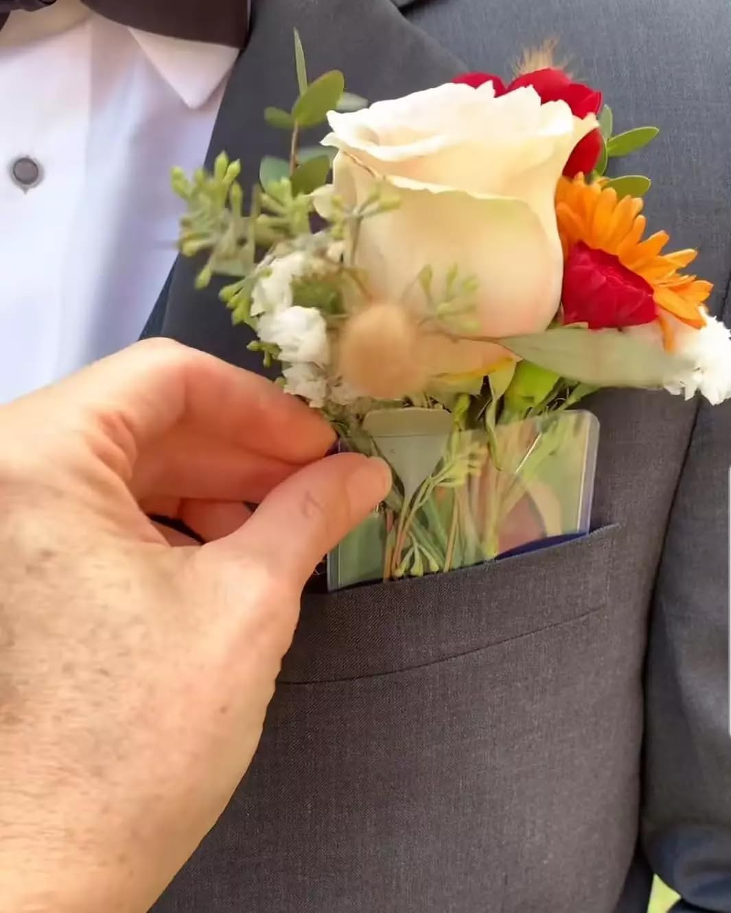 Clear pocket boutonniere sleeve worn in a suit jacket pocket